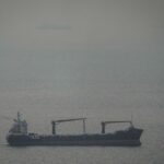 A cargo ship carrying vehicles sails through the Arabian Gulf toward the Strait of Hormuz in the United Arab Emirates, Sunday, March 22, 2026. (AP Photo)
