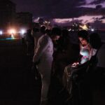 People spend the night in the dark on the Malecon during a blackout in Havana, Cuba, Saturday, March 21, 2026. (AP Photo/Ramon Espinosa)