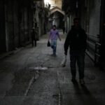FILE - People walk past closed shops at the nearly empty traditional main bazaar during Iranian New Year, or Nowruz, holidays in Tehran, Iran, Sunday, March 29, 2026. (AP Photo/Vahid Salemi, File)