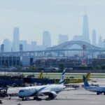 FILE - The New York City skyline is seen behind Newark Liberty International Airport in Newark, N.J., Wednesday, May 7, 2025. (AP Photo/Seth Wenig,File)