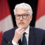 Privacy Commissioner Philippe Dufresne listens to a question during a news conference in Ottawa, Wednesday, May 6, 2026. THE CANADIAN PRESS/Adrian Wyld