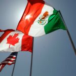 FILE - National flags representing the United States, Canada, and Mexico fly in the breeze in New Orleans where leaders of the North American Free Trade Agreement met on April 21, 2008. (AP Photo/Judi Bottoni, File)