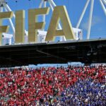 Fans of both teams cheer under a FIFA sign in the stands during group B World Cup soccer action between Canada and Bosnia and Herzegovina, in Toronto, Friday, June 12, 2026. THE CANADIAN PRESS/Sammy Kogan