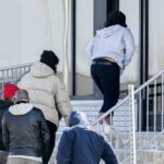 People enter a processing centre at the Canada/US border crossing in Saint-Bernard-de-Lacolle, Que., Thursday, April 10, 2025. THE CANADIAN PRESS/Graham Hughes