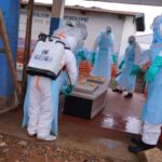 Health workers disinfect a coffin of an Ebola victim at Ebola Treatment Center at Bunia General Hospital in Ituri, Congo, Wednesday, July 22, 2026. (AP Photo/Dirole Lotsima Dieudonne)