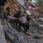 People carry a body of a person who was killed at a house that was hit by an Israeli airstrike in Arab Salim village, southern Lebanon, Sunday, Sept. 6, 2026. (AP Photo/Mohammed Zaatari)