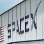 The SpaceX logo is displayed on a building, Tuesday, May 26, 2020, at the Kennedy Space Center in Cape Canaveral, Fla. (AP Photo/David J. Phillip, File)