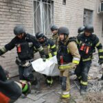 Rescue workers carry a body after pulling from the rubble of a residential building destroyed by a Russian airstrike in Zaporizhzhia, Ukraine, Saturday, Oct. 10, 2026. (AP Photo/Kateryna Klochko)