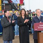 From left, Scott Burrows, CEO of the Pembina Pipeline Corp, Alberta Premier Danielle Smith and Prime Minister Mark Carney applauded after speaking in Fort McMurray on Thursday Oct. 1, 2026. Prime Minister Mark Carney declared the Pacific Link pipeline project to be in the national interest. THE CANADIAN PRESS/Greg Halinda
